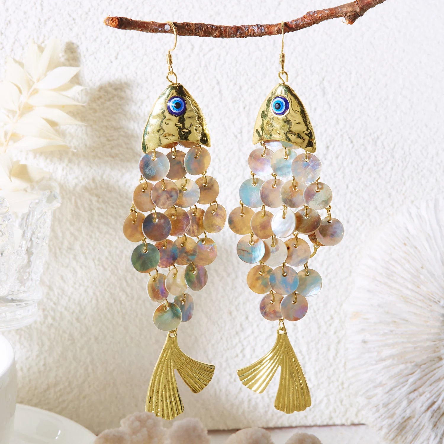 Koi charm drop earrings with gold-tone blue eye and iridescent bead tassels.