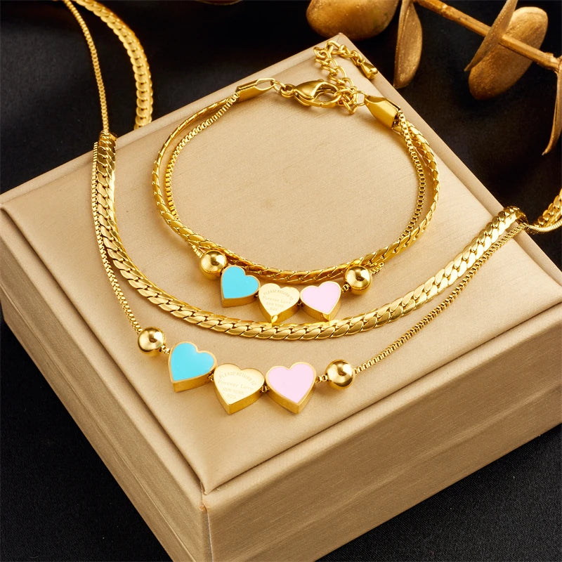 Gold double-layer heart necklace and matching bracelet with blue and pink enamel hearts