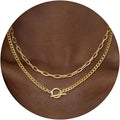 Gold layered chain necklace with oval connector and mixed link styles