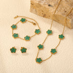 Clover jewelry set with green enamel clover charms on gold-tone chains, bracelet and necklace