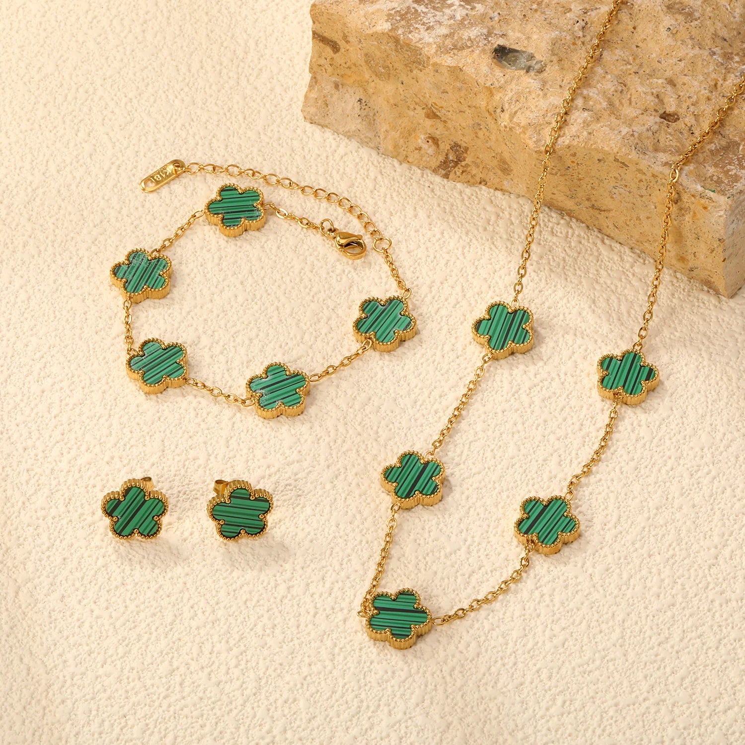 Clover jewelry set with green enamel clover charms on gold-tone chains, bracelet and necklace