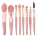 Makeup brush set with blush pink handles and soft tapered bristles; includes spoolie