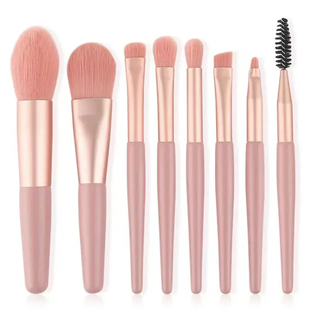 Makeup brush set with blush pink handles and soft tapered bristles; includes spoolie
