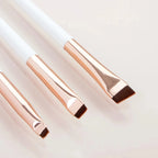 Eyeliner and eyebrow makeup brushes, three pale handles with angled brown bristles