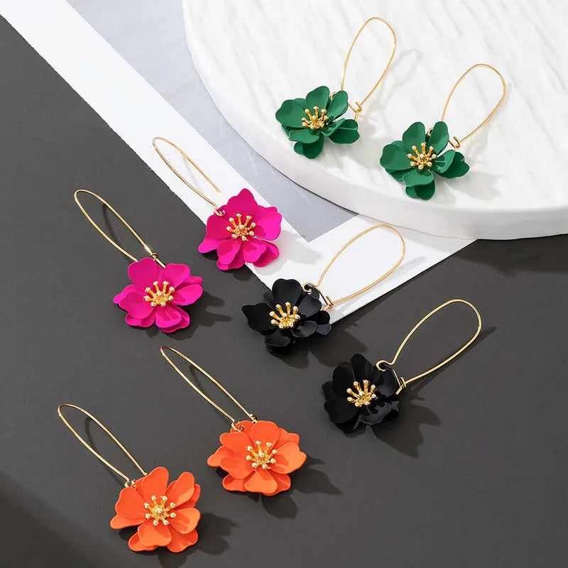 Floral stud earrings in pink, black, green, and orange with gold-tone hooks