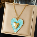 Blue enamel heart pendant necklace with gold inner heart on gold chain