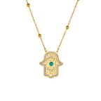 Gold-tone hamsa hand pendant necklace with turquoise center and link chain