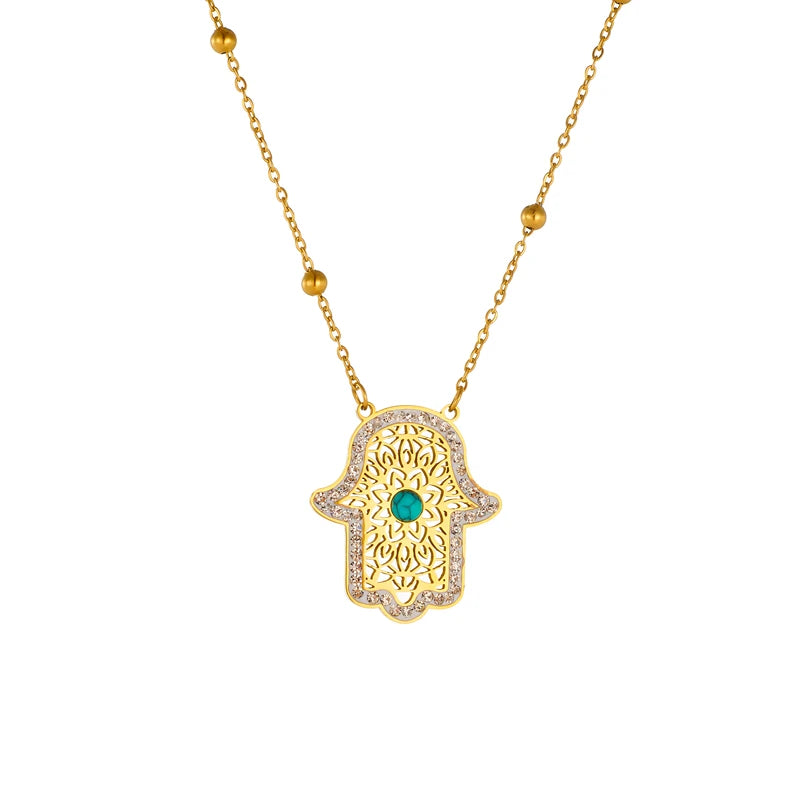 Gold-tone hamsa hand pendant necklace with turquoise center and link chain