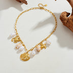 Gold-tone ocean charm necklace with pearl drops and shell, crab, turtle pendants