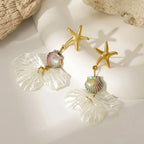 Gold starfish earrings featuring a rainbow scalloped bead and layered white petal drops