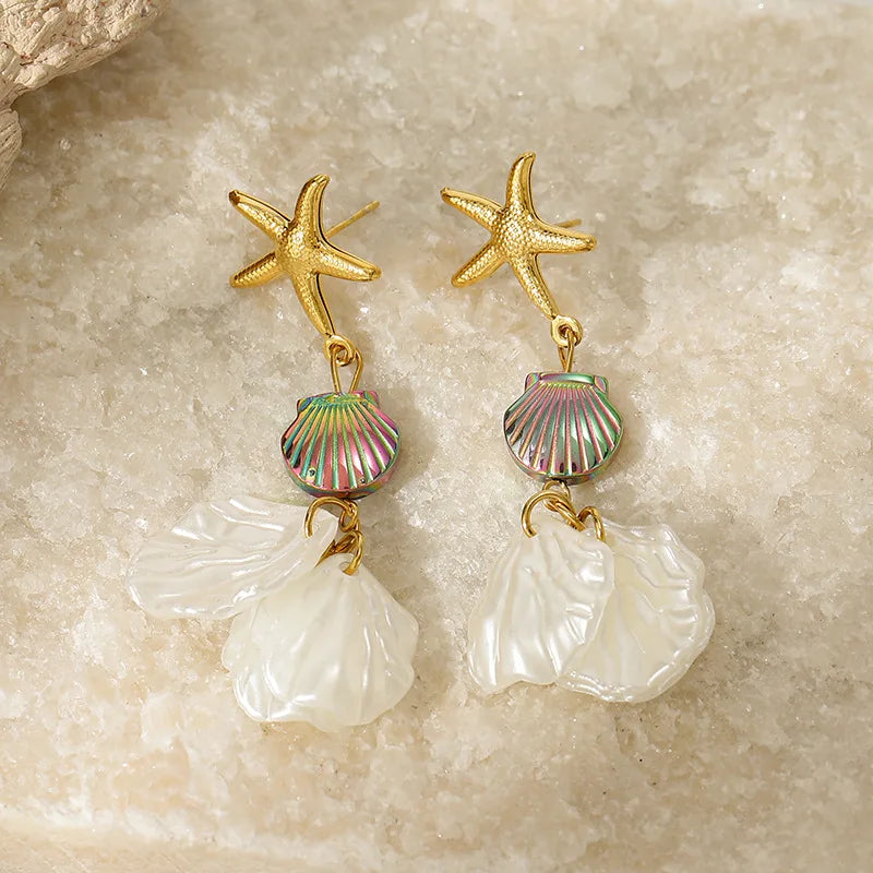 Gold starfish earrings with rainbow striped bead and translucent white petal drops