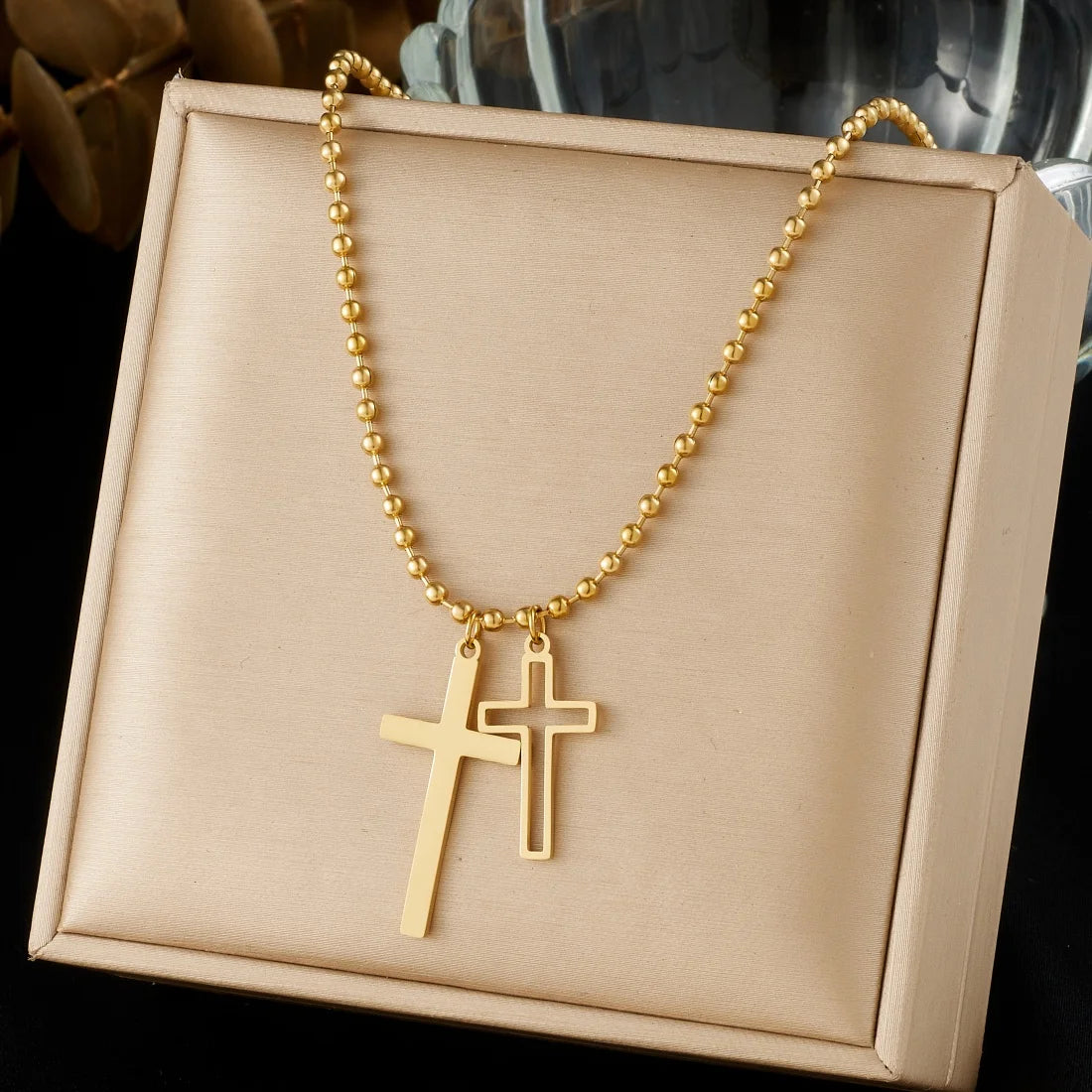 Gold cross pendant necklace with double cross charm on a beaded chain