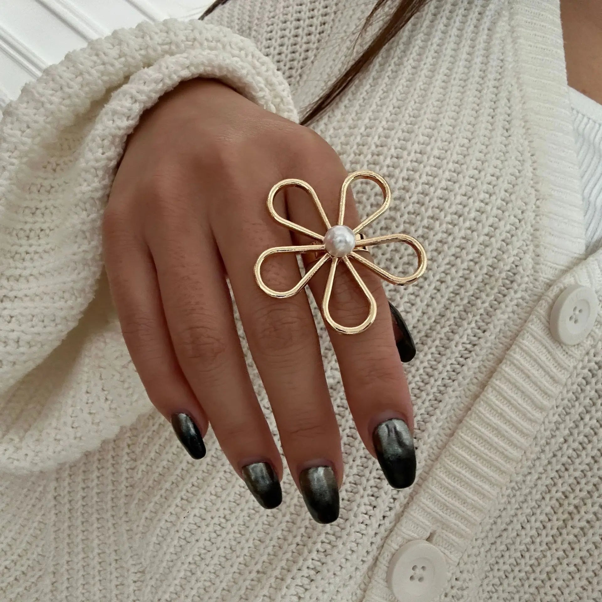 Starfish pearl ring on hand with round white pearl and gold band