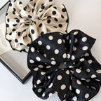 Polka dot scrunchie set with black and white fabric bows and elastic gathers