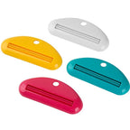 Toothpaste tube squeezer dispenser set in white, yellow, teal, and pink with metal strips