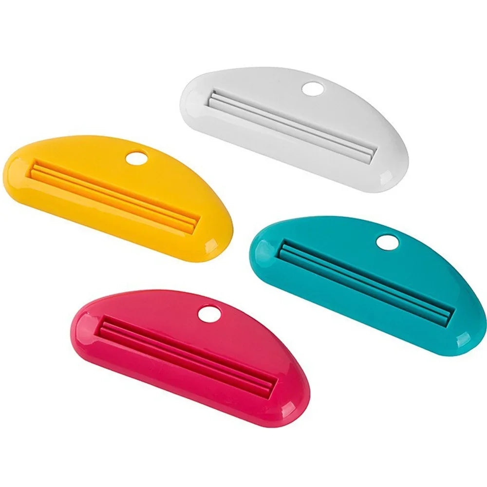 Toothpaste tube squeezer dispenser set in white, yellow, teal, and pink with metal strips