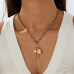 Jellyfish pendant necklace with starfish charm and white shell bead on blue gold chain