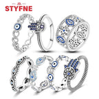 Sterling silver evil eye rings collection with blue eye inlays, hearts, and openwork