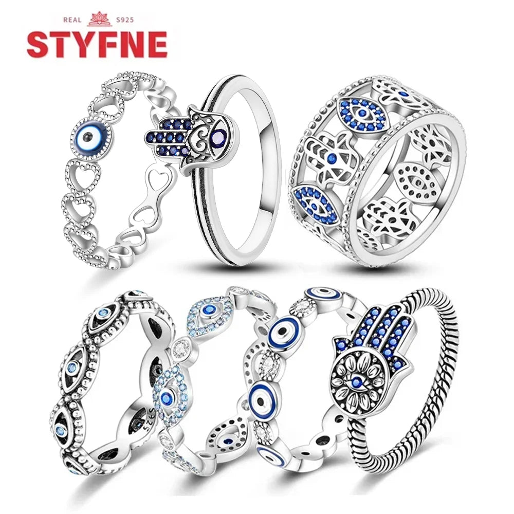 Sterling silver evil eye rings collection with blue eye inlays, hearts, and openwork