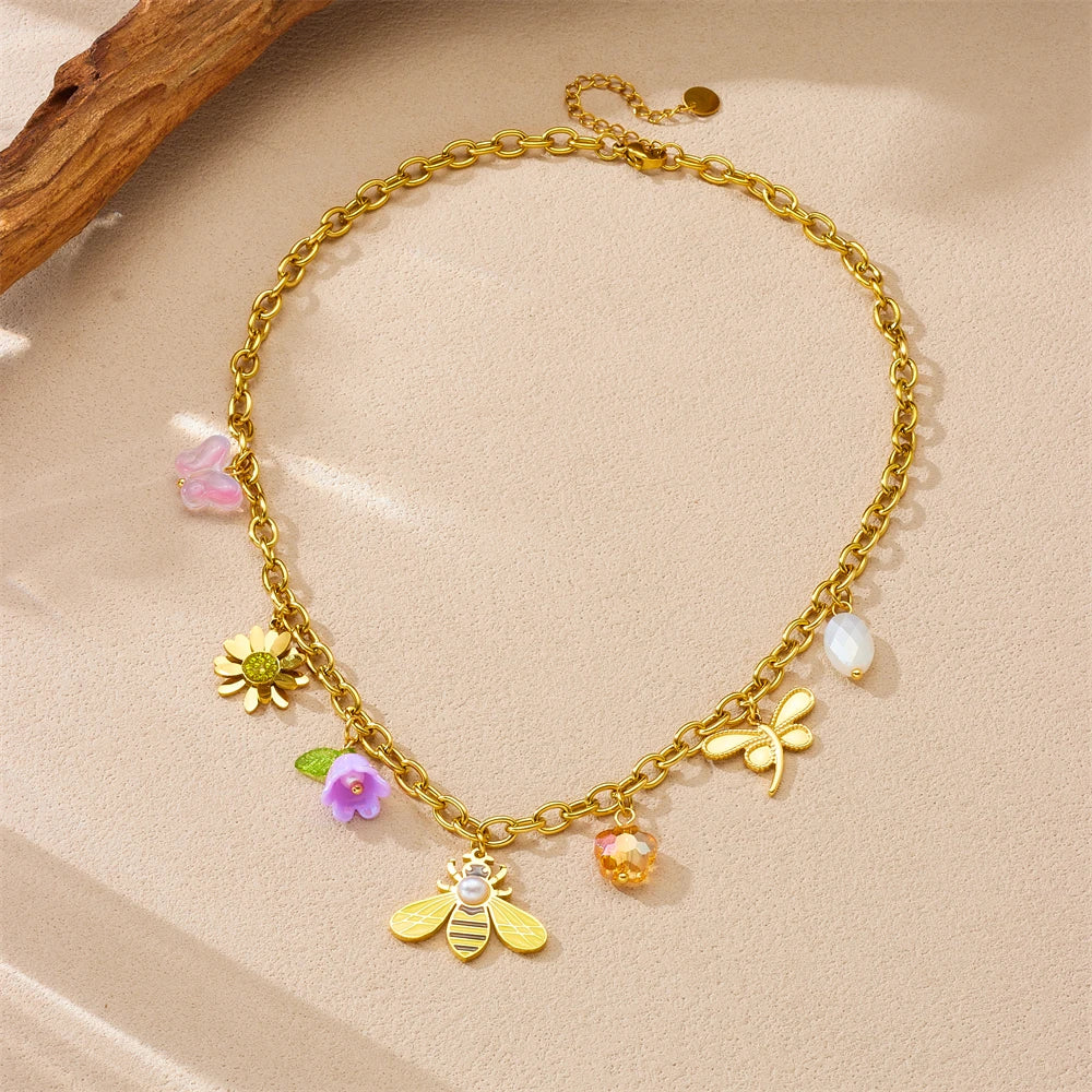 Gold-tone bee and flower charm bracelet with pearl and pastel resin dangles