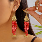 Gold-tone koi charm drop earrings with red bead tassels and fish-tail dangles.