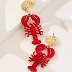 Red lobster charm earrings with gold scallop shell tops and dangling lobster shape