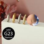 Titanium belly button clicker rings, gold and silver hoops on display