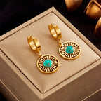 Gold-tone hoop earrings with turquoise eye disc dangles