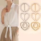 Metal scarf knot brooch clip with faux pearls, securing a folded fabric scarf
