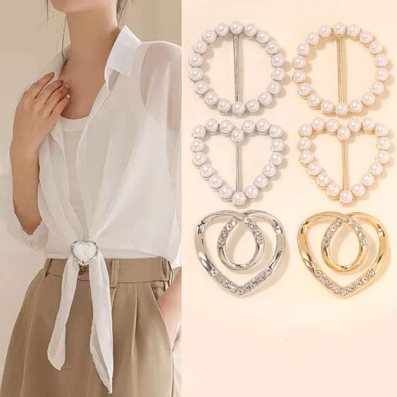 Metal scarf knot brooch clip with faux pearls, securing a folded fabric scarf