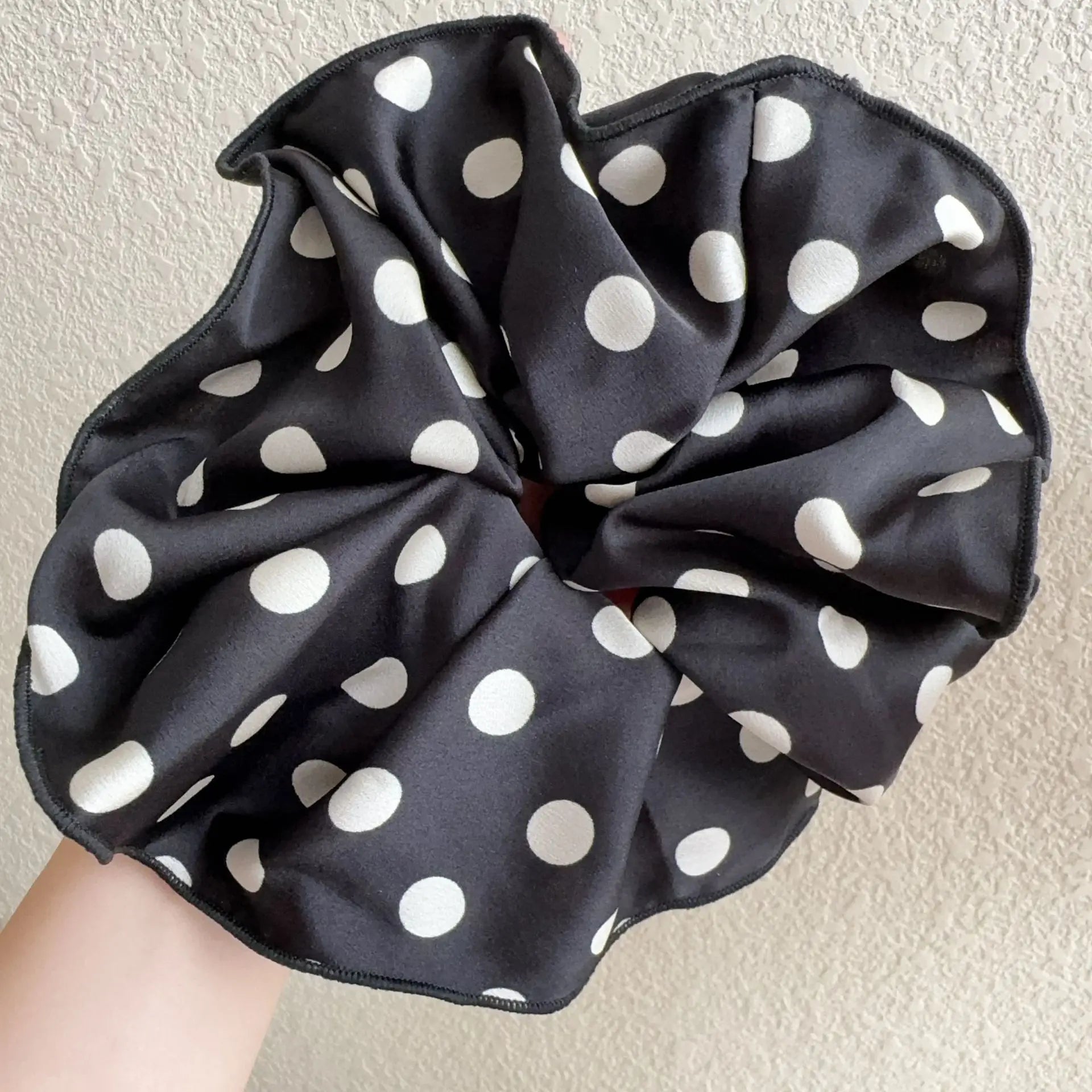 Black cotton polka-dot scrunchie with white dots, gathered circular bow