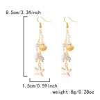 Boucles d'oreilles pendantes bohème à pompons — Étoile de mer et coquillage