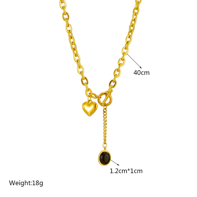 Gold-tone chain necklace with heart charm and round black stone pendant