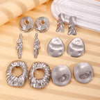 Assorted metal drop earrings with textured round hoops and heart-like studs