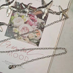 Silver-tone starfish waist belly chain laid across a jewelry display card