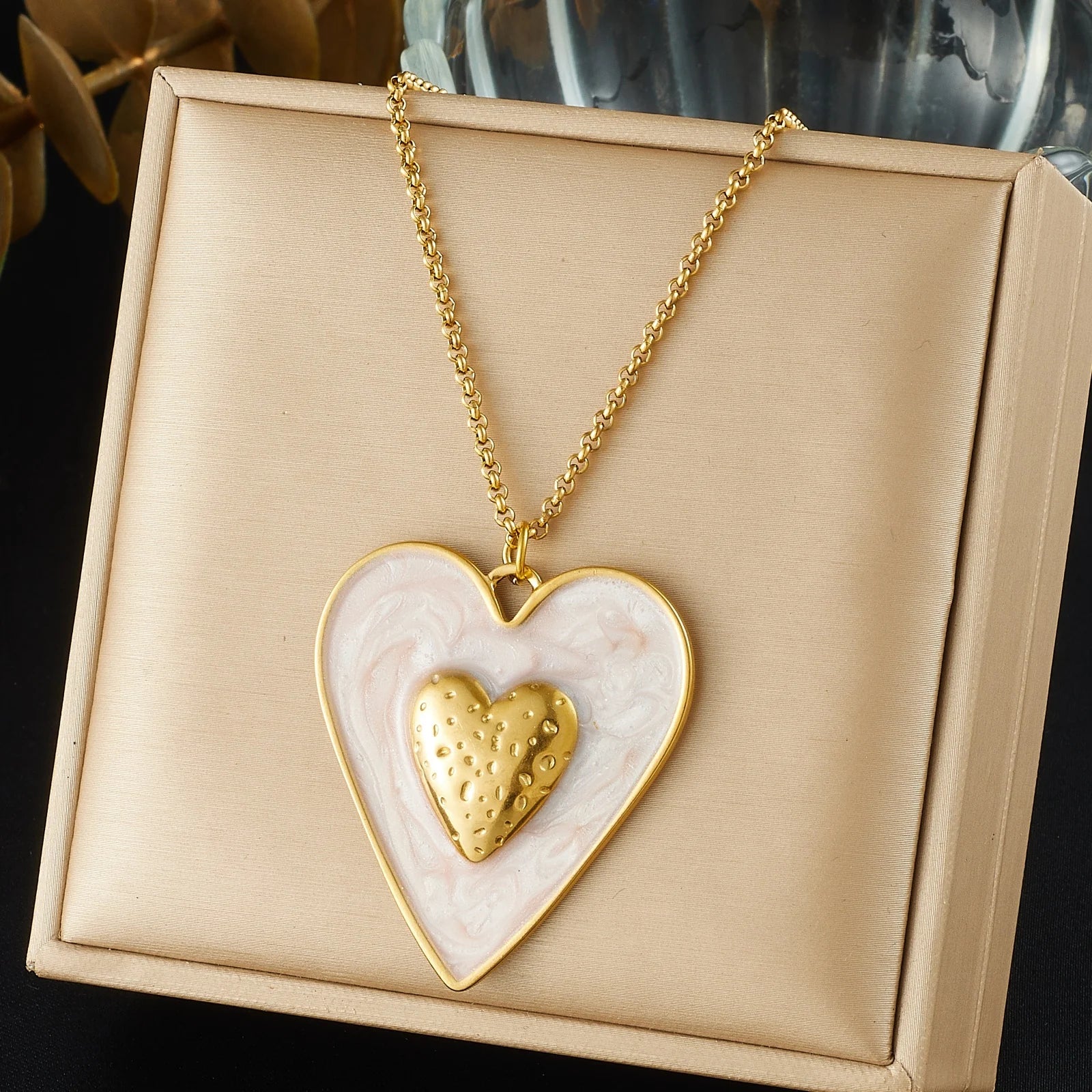 Gold chain necklace with white enamel heart pendant and gold inner heart