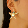 Gold starfish stud earrings with multicolor gemstone-like stones