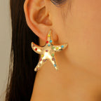 Gold starfish stud earrings with multicolor gemstone-like stones