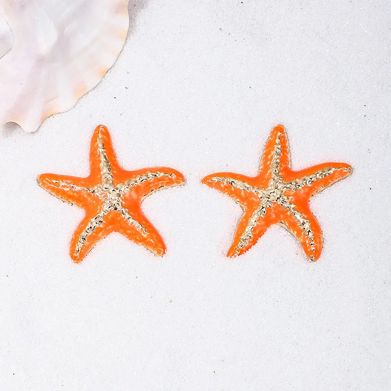 Starfish stud earrings, orange starfish with silver-tone texture, close pair view