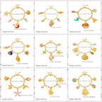 Gold-tone enamel ocean charm bracelet with mixed seashell, dolphin and starfish charms