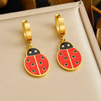 Gold tone hoop earrings with ladybug drop charms