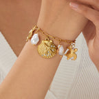 Gold-tone ocean charm bracelet with pearls and crab, turtle, scallop shell pendants