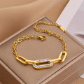 Gold thick chain geometric bracelet with rectangular links and clear pave center