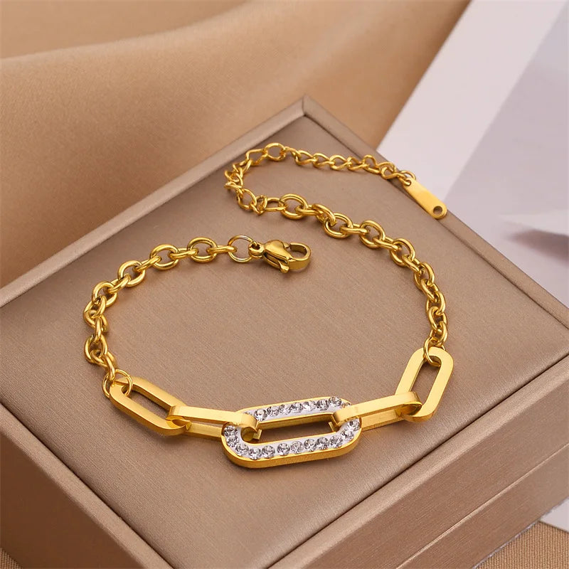 Gold thick chain geometric bracelet with rectangular links and clear pave center