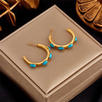 Gold-tone hoop earrings with turquoise bead dangles