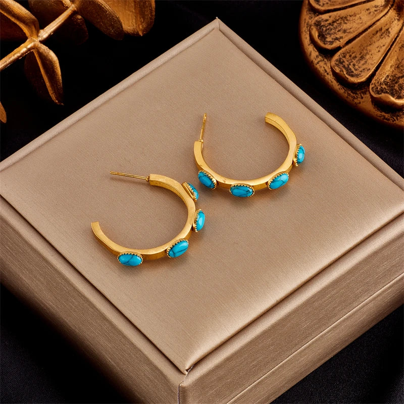 Gold-tone hoop earrings with turquoise bead dangles