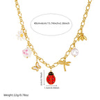 Gold-tone ladybug charm necklace with flower and pearl drop details; length-mark diagram