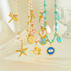 Turquoise beaded pendant necklace with starfish, flower, sun-eye and moon charms