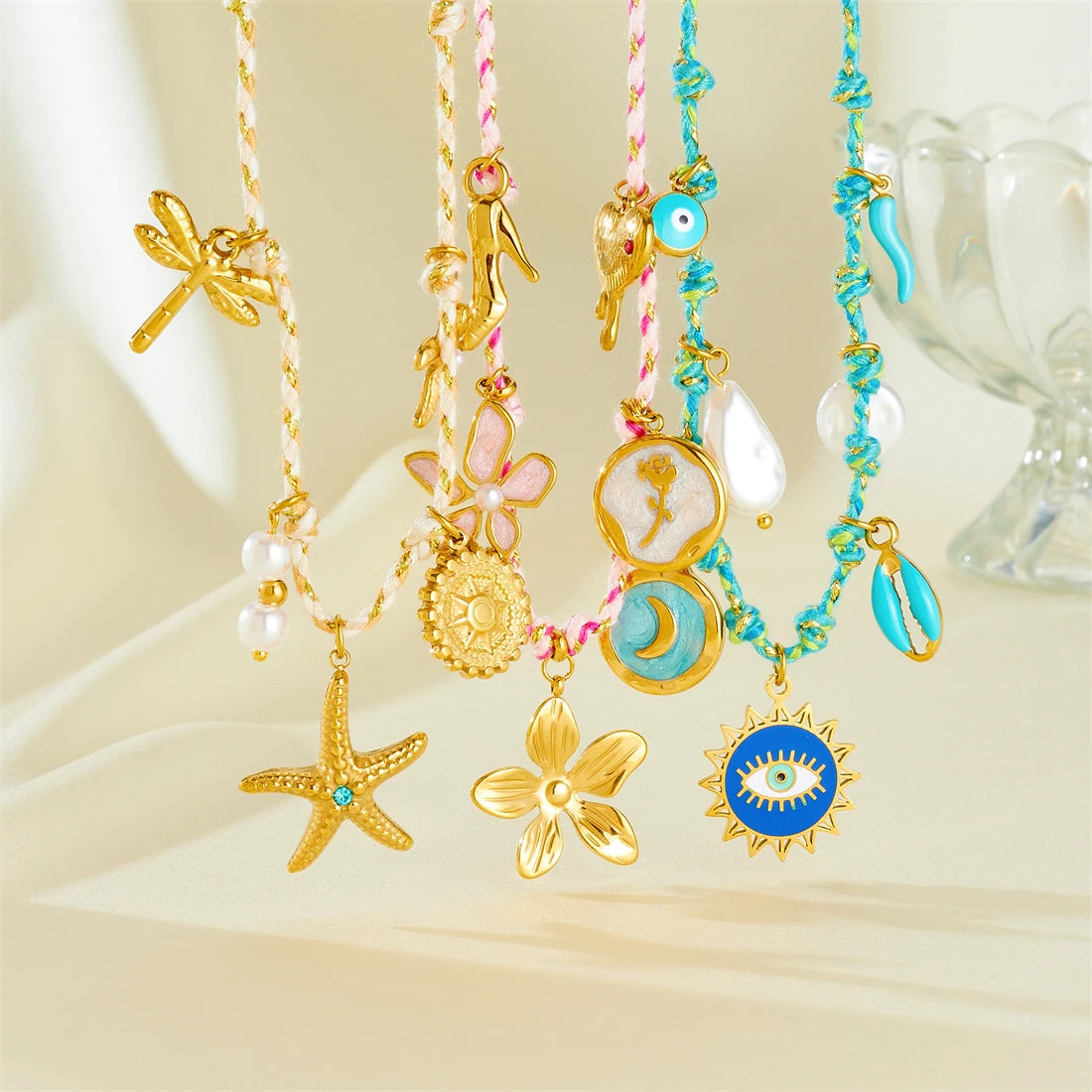 Turquoise beaded pendant necklace with starfish, flower, sun-eye and moon charms