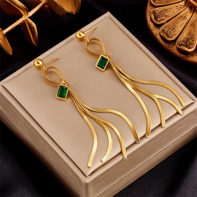 Gold hoop earrings with green square stones and long chain tassel drops